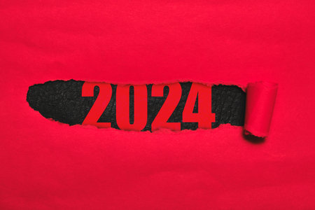 Figures for 2024 are black background with torn red paperの写真素材