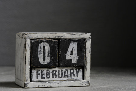 February 04 on wooden calendar, on dark gray backgroundの写真素材