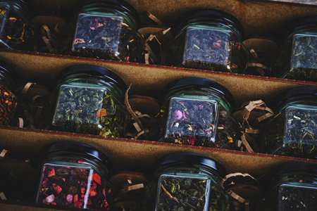 Set of various leaf tea packaged in jars. Black and green healthy tea with fruits, berries and herbs