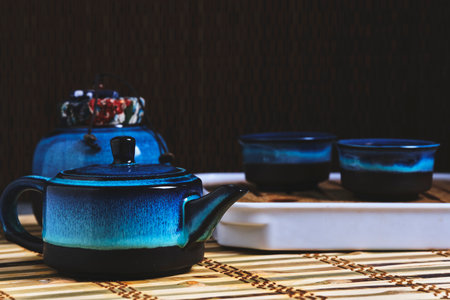 Tableware for tea ceremony . Blue tea set pottery on bamboo napkinの写真素材