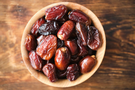 Dried dates in wooden cup. Fruits and healthy food