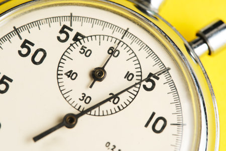 Mechanical stopwatch yellow background closeupの写真素材