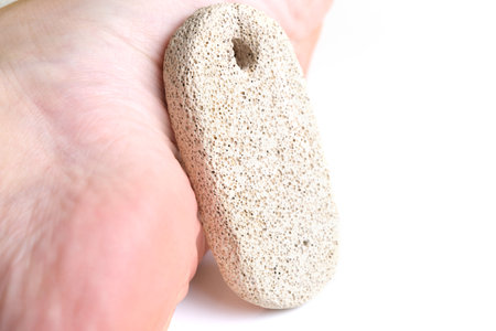 Pumice stone for cleaning feet and heels, on white backgroundの写真素材