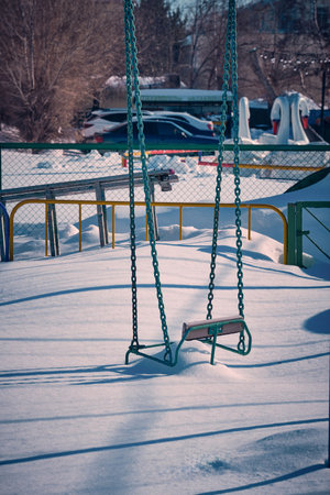 Chain swing is covered with snowの写真素材