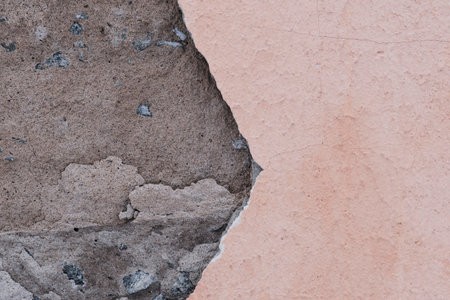 Fallen plaster from wall. Poor quality repairs. Crumbling facade buildingの写真素材