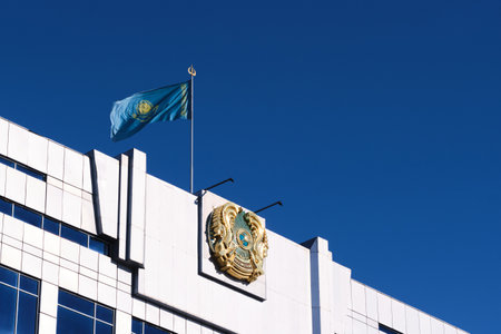 Kazakhstan Kostanay February 18, 2024.Flag Kazakhstan flutters wind above coat armsのeditorial素材