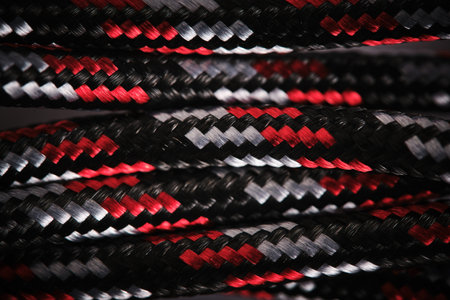 Abstract background with cable in black and white and red cloth braidの写真素材