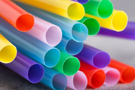 Colored drinking straws on a gray background, close-upの写真素材