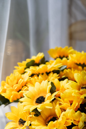 Bouquet of yellow sunflowers on the windowsill.の写真素材