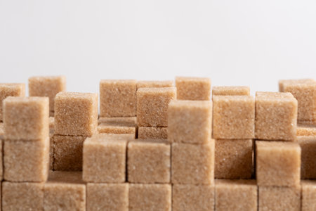cubes of brown sugar on a white background, close-upの写真素材