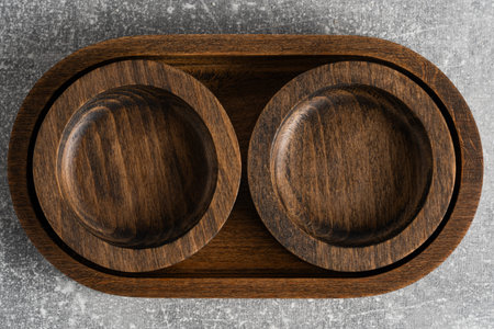 Top view of two wooden bowls on a grunge background. View from above.
