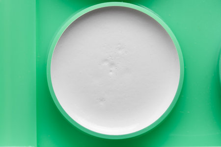 Plastic tableware in the form of a circle with foam.の写真素材