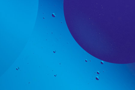 Blue and purple bubbles float on a dark blue background, creating a serene and tranquil abstract pattern with a calm visual effectの写真素材