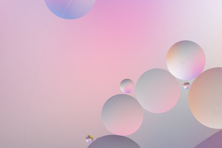 Circles in varying sizes on a pink and purple gradient background, creating an abstract, dreamy, and...