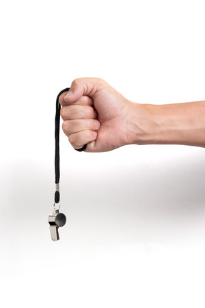 Hand with whistle isolated on white background.の写真素材