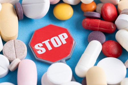 Pills and stop sign on blue background.の写真素材