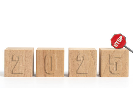 Wooden cubes with inscription 2025 and stop sign on white background.