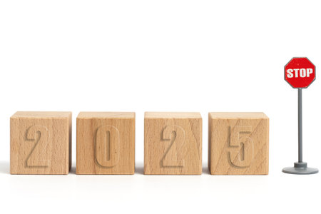 Wooden cubes with inscription 2025 and stop sign on white background.