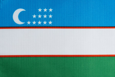 Flag of Uzbekistan, national country symbol. Fabric texture background.の写真素材