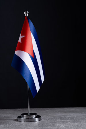 National flag  Cuba on  metal flagpole on black background.の写真素材