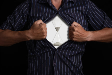 Man tears open his shirt, revealing an hourglass symbolizing time, patience and life cycles