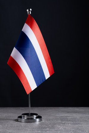 Thailand flag on a stand on a black background. Copy space.の写真素材