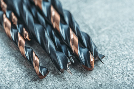 Set of drill bits on a gray background. Selective focus.の写真素材