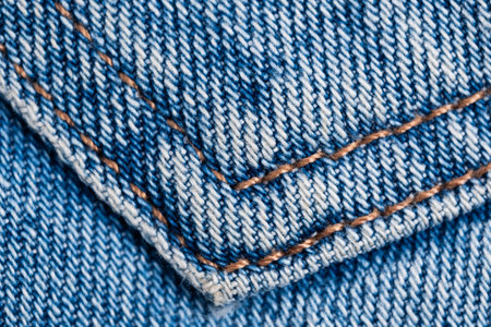 Jeans texture. Closeup of blue jeans fabric with stitch.の写真素材
