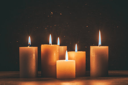 Burning candles on a dark background. Shallow depth of field.