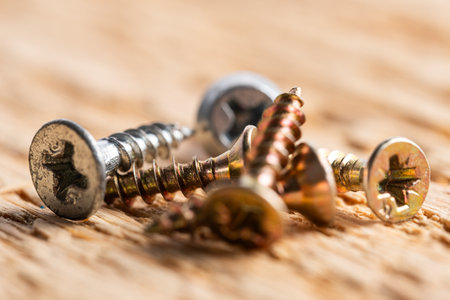 Screws on a wooden background. Close-up. Selective focus.の写真素材
