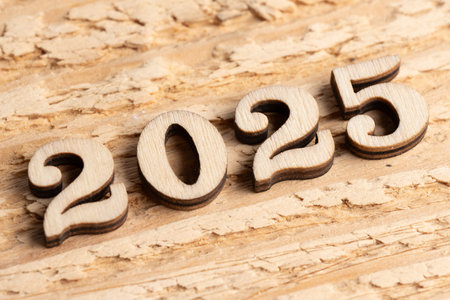 New year 2025 with wood numbers on rustic wooden background.の写真素材