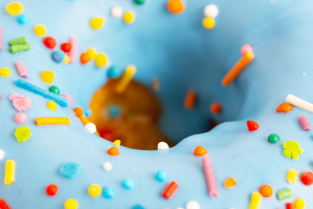 Doughnut with blue icing and sprinkled with multicolored sprinkles.Close-up.の写真素材