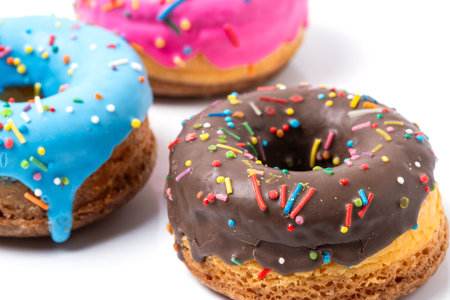 Colorful donuts isolated on white background. Closeup.の写真素材