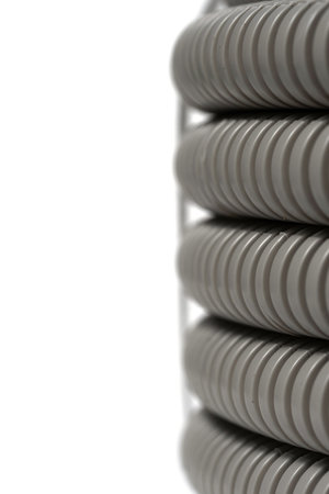 Close-up of a row of white plastic pipes on a white background