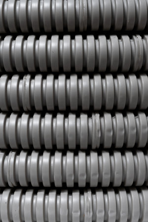 Abstract background depicting row grey corrugated plastic pipes in warehouse.の写真素材