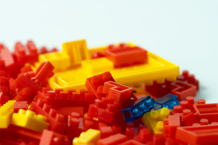 Plastic building blocks on a white background, close-up.