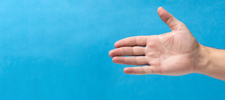 Man palm on a blue background. Copy space for text.の写真素材