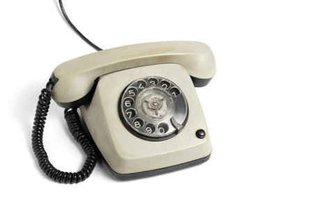 Old disk phone, highlighted on retro style white background.の写真素材