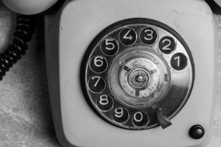 Vintage telephone on the cement floor. Black and white tone.の写真素材