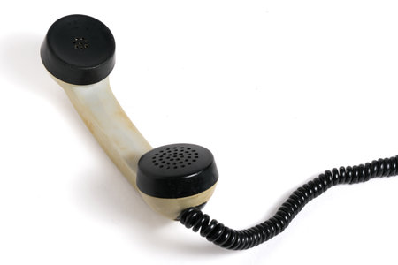 Retro telephone on a black background. Man's hand holds the handset.の写真素材