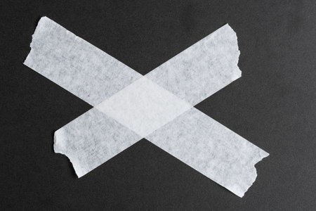 Masking paper tape is pasted on a black background.