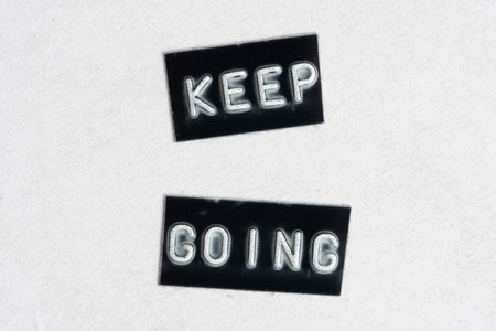 Keep Going sign in black and white on a white background close upの写真素材