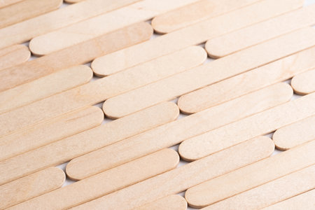 Wooden ice cream sticks on white background.  Abstract background and texture for design.