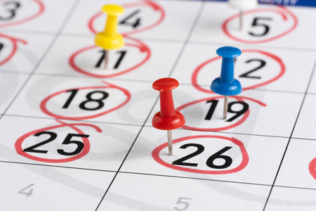 Calendar marked with red pin on white background, close-upの写真素材