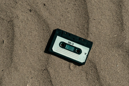 Vintage audio cassette tape in the sand. Retro concept. Toned.の写真素材