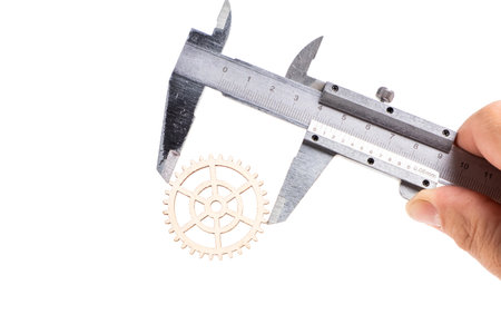 Vernier caliper with gear wheel on white background. Industrial concept. Isolatedの写真素材