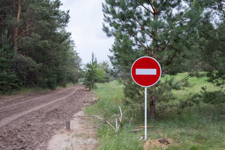 No entry sign on  dirt road in  forest. Conceptual photo.の写真素材
