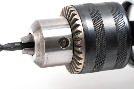 Chuck for tightening drill bit on  drill closeup on white background.