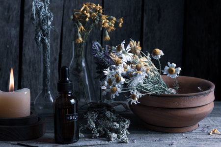 Herbal medicine with chamomile flowers and aromatherapy oilの写真素材