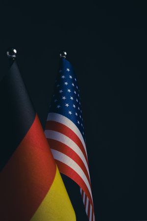 Flag  United States and Germany on  dark background.